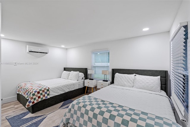 1899 NE 49th Ct, Pompano Beach, FL 33064 - bedroom featuring light hardwood / wood-style floors and a wall mounted AC