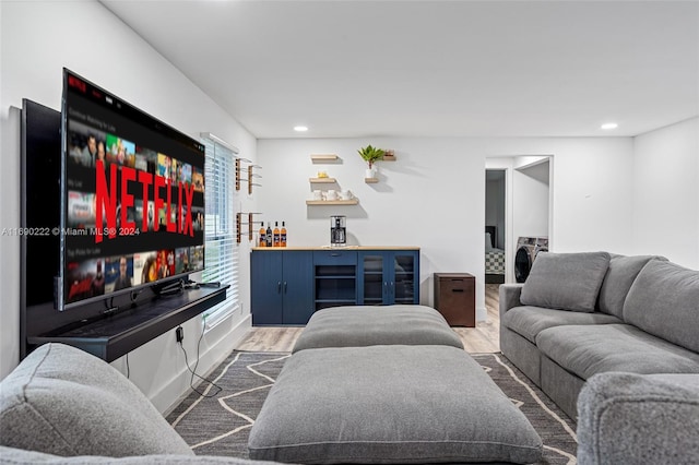 living room featuring washer / clothes dryer and wood-type flooring