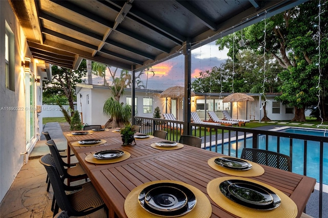 deck at dusk with a patio area and a shed