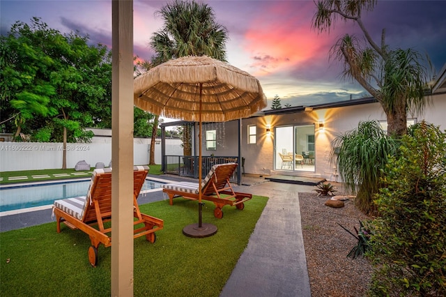 exterior space with a fenced in pool and a patio