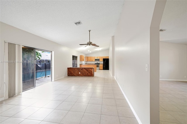 unfurnished living room featuring a textured ceiling, vaulted ceiling, ceiling fan, and light tile patterned flooring