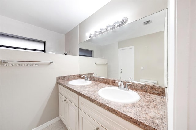 bathroom with tile patterned floors, vanity, and toilet