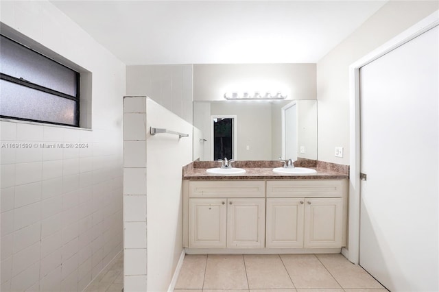 bathroom with vanity, tile patterned floors, and tile walls