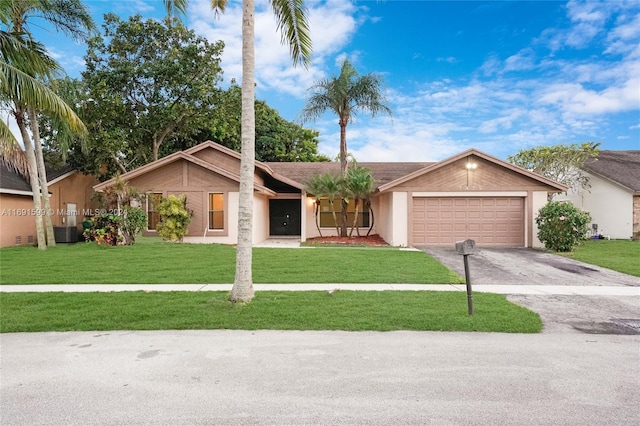 ranch-style house featuring a garage, a front lawn, and cooling unit