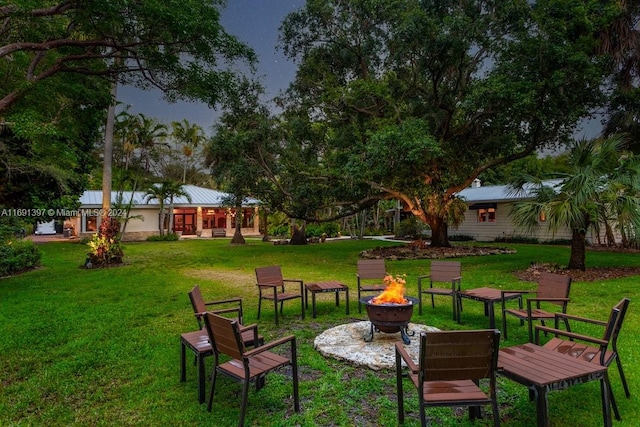 view of yard with a fire pit