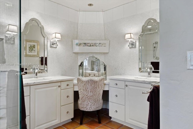 full bath featuring a sink, two vanities, and tile walls