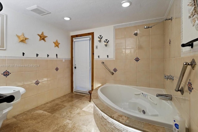 bathroom with a textured ceiling, plus walk in shower, and tile walls