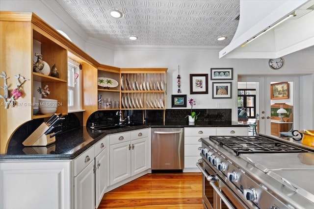 kitchen featuring french doors, white cabinets, crown molding, light hardwood / wood-style flooring, and appliances with stainless steel finishes