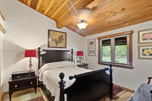 bedroom with vaulted ceiling with beams, baseboards, light tile patterned floors, and wooden ceiling