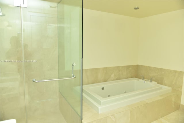 bathroom featuring separate shower and tub