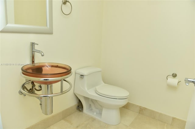 bathroom with tile patterned floors, toilet, and sink