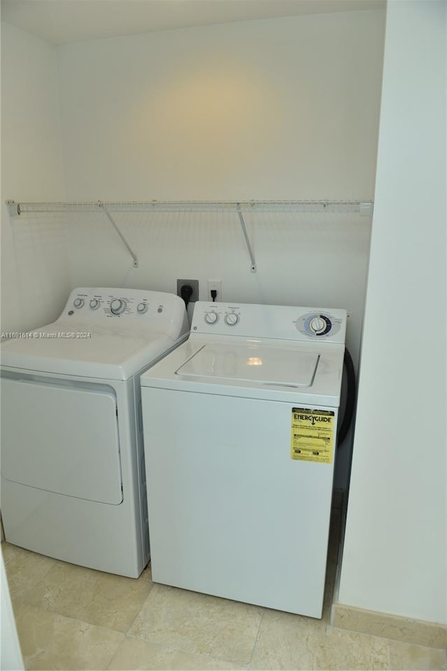 washroom with washing machine and clothes dryer