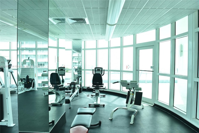 gym with a wall of windows