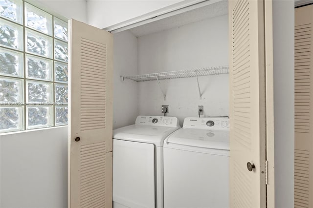 clothes washing area featuring independent washer and dryer