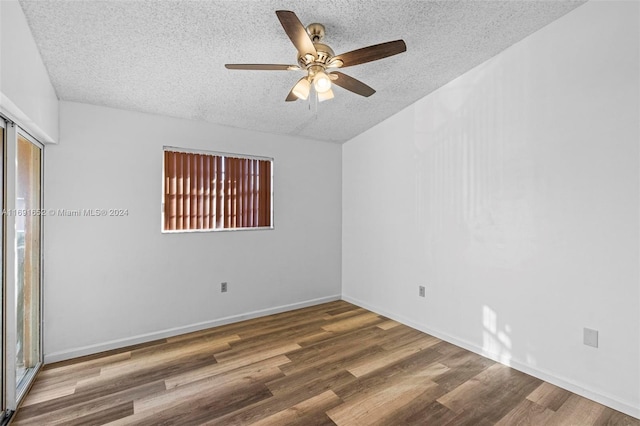 spare room with ceiling fan, wood-type flooring, and a textured ceiling