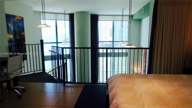 bedroom featuring expansive windows and tile patterned floors