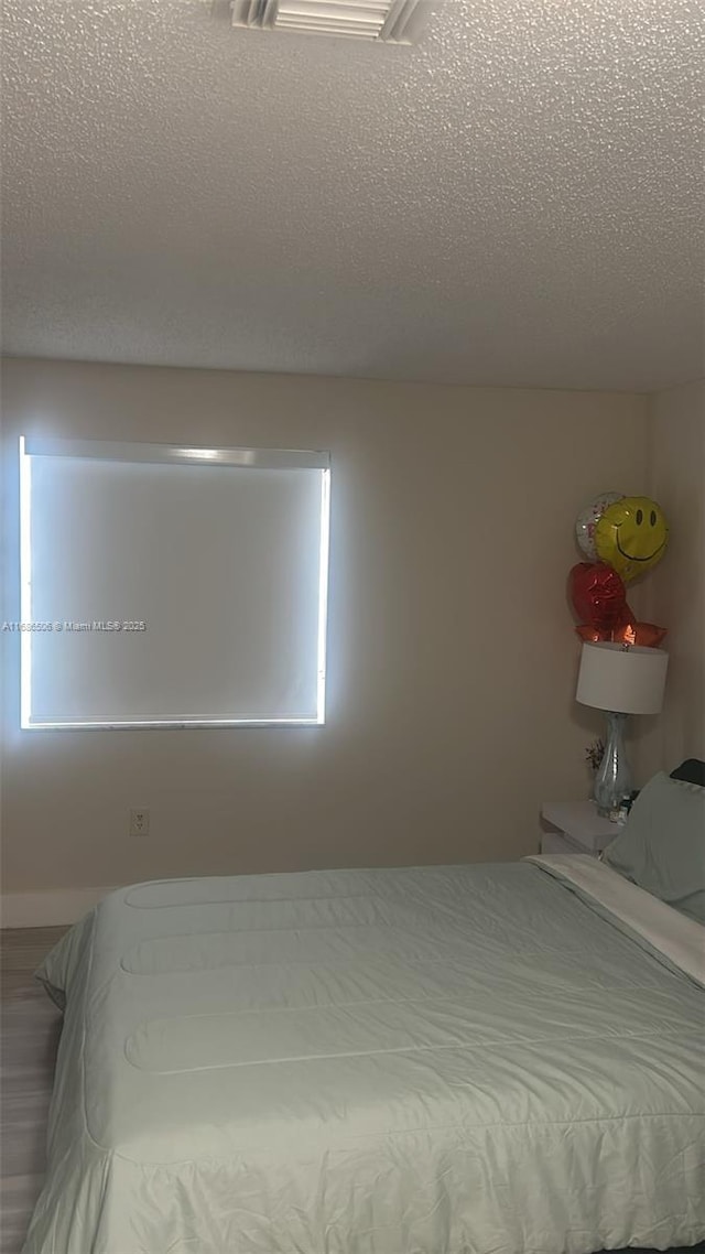 bedroom featuring a textured ceiling