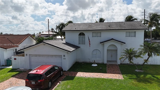 view of front of home with a garage and a front lawn