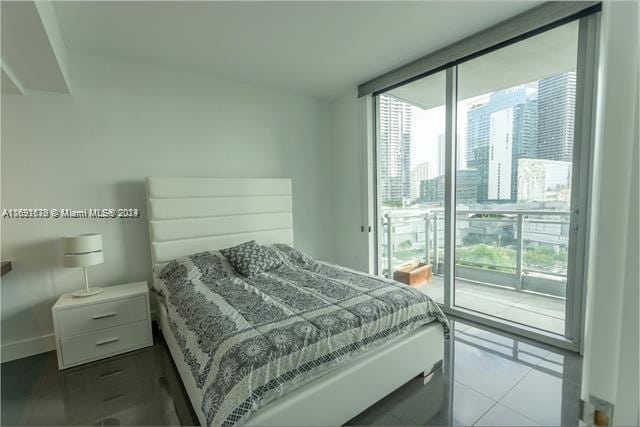 bedroom featuring light tile patterned floors and access to outside