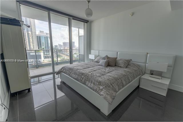 tiled bedroom featuring access to outside