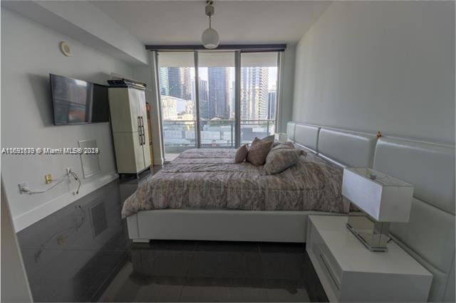 bedroom featuring dark tile patterned flooring