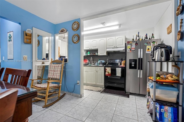 kitchen with electric range, sink, light tile patterned floors, stainless steel fridge with ice dispenser, and white cabinets