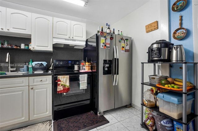 kitchen featuring stainless steel fridge with ice dispenser, white cabinetry, black electric range, light tile patterned flooring, and sink