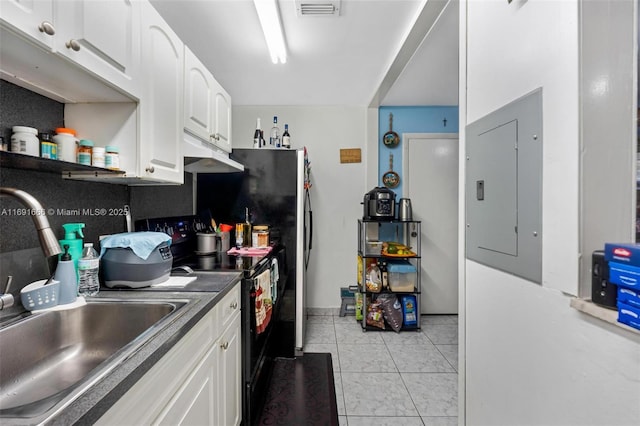 kitchen with light tile patterned floors, black electric range, electric panel, white cabinets, and sink