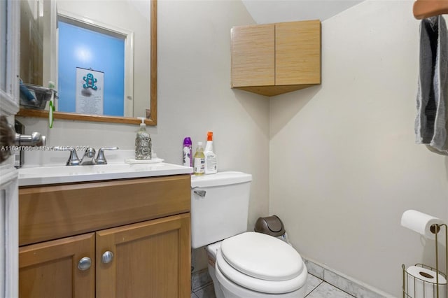 bathroom featuring toilet, tile patterned flooring, and vanity