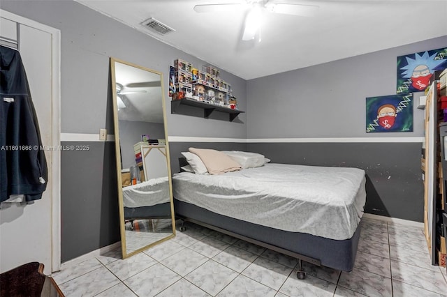 bedroom with ceiling fan and tile patterned floors