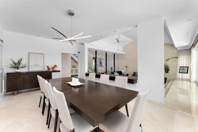 dining area with ceiling fan with notable chandelier and light tile patterned floors