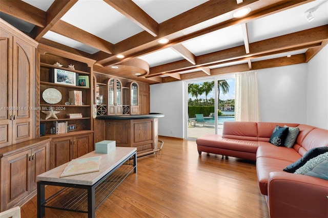 living room featuring light wood-type flooring and beam ceiling