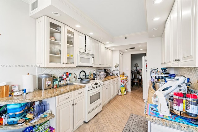 kitchen with white appliances, crown molding, decorative backsplash, light wood-type flooring, and white cabinetry