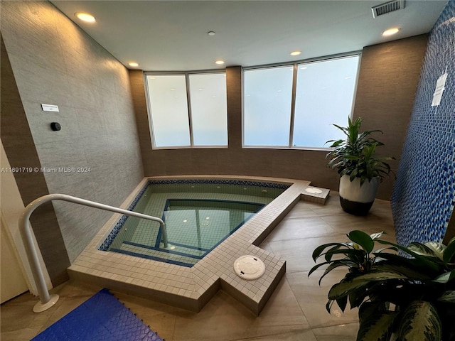 view of swimming pool with an indoor hot tub