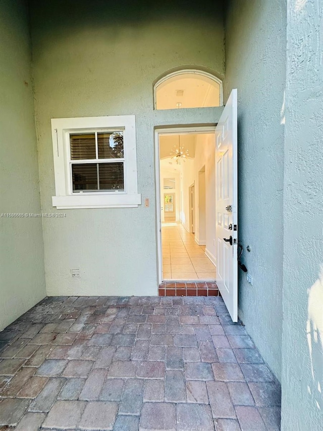 view of exterior entry with a patio area