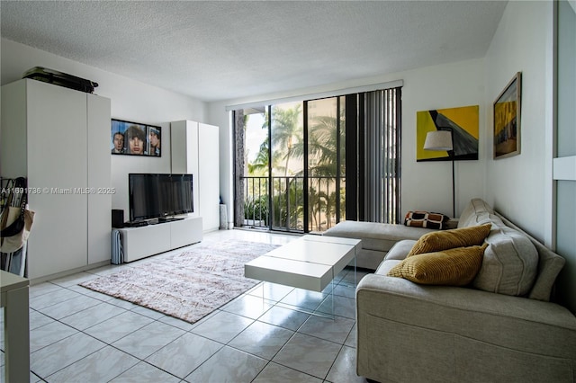 living area with a textured ceiling and floor to ceiling windows