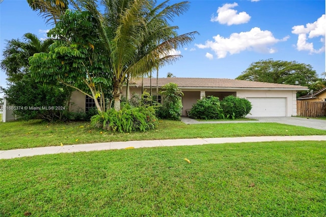 view of front of house featuring a front lawn and a garage