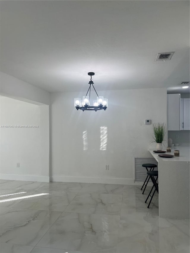 unfurnished dining area with a chandelier