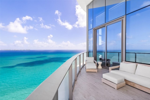 balcony featuring outdoor lounge area and a water view