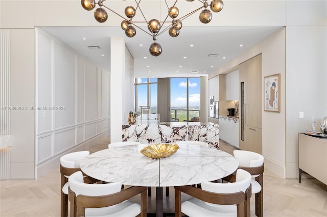 dining area featuring floor to ceiling windows, light parquet flooring, a chandelier, and radiator