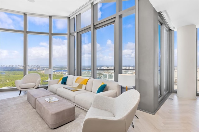 living room featuring a wealth of natural light, light parquet floors, and expansive windows