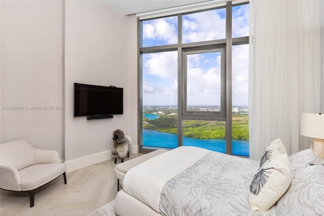 bedroom featuring floor to ceiling windows and parquet floors