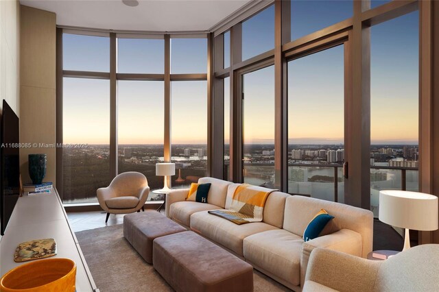 living room with a water view and floor to ceiling windows