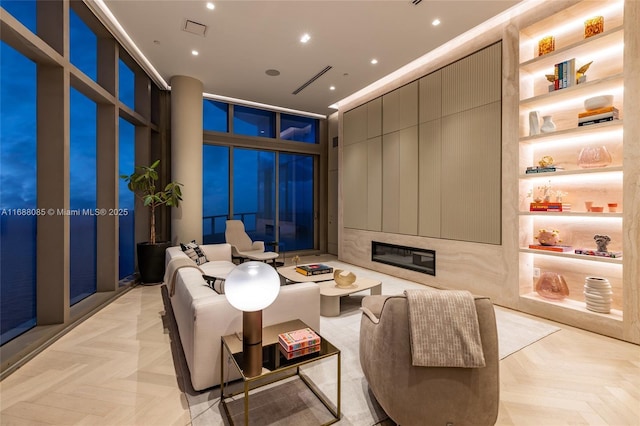 living room with light parquet flooring and floor to ceiling windows