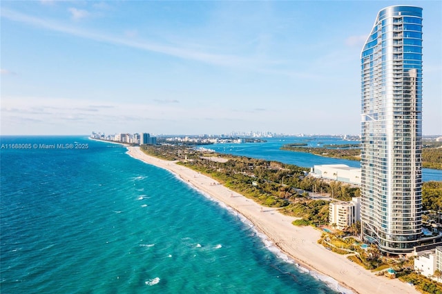 aerial view with a water view and a beach view