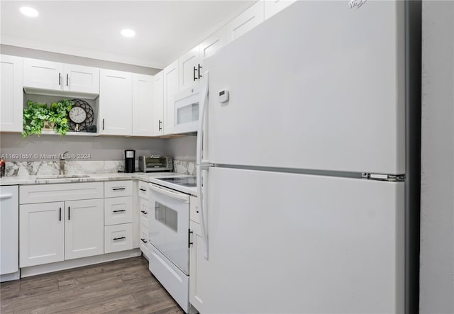 kitchen with white cabinets, dark wood-type flooring, sink, and white appliances