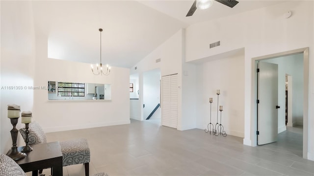 living area with visible vents, high vaulted ceiling, baseboards, and ceiling fan with notable chandelier