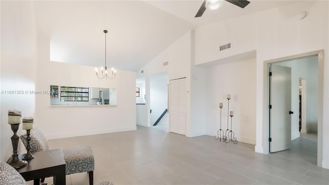 living room featuring ceiling fan with notable chandelier and high vaulted ceiling