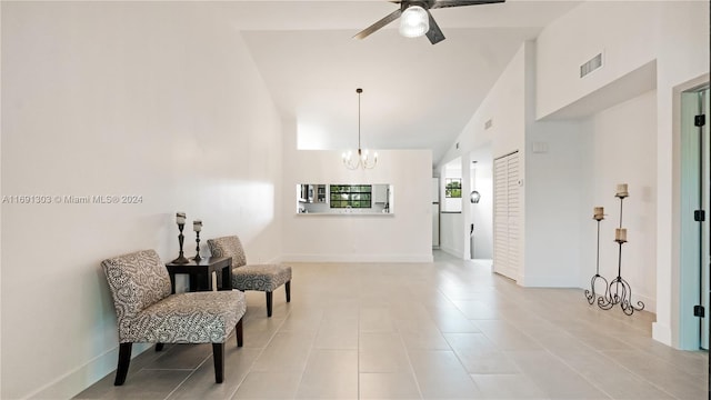 sitting room featuring ceiling fan with notable chandelier and light tile patterned floors