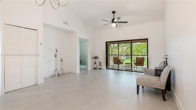 living area featuring visible vents, high vaulted ceiling, and ceiling fan